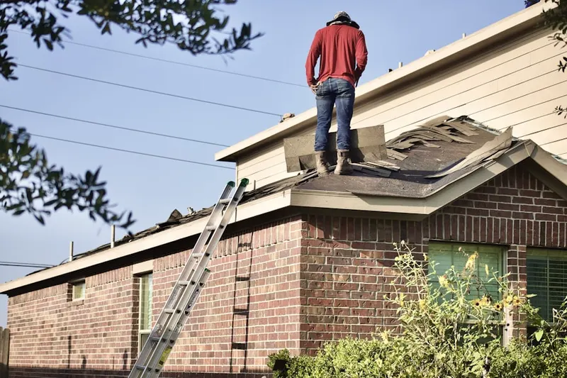 Professional roofer working on a residential roof in Glen Allen